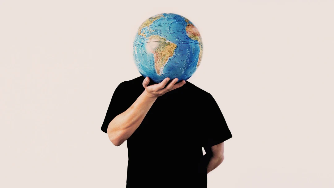 Man holding globe of Planet Earth.