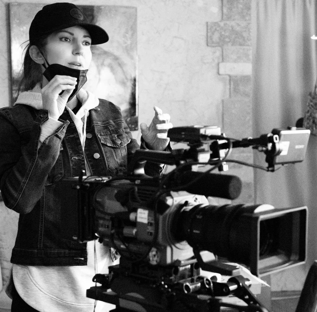 Amanda Cryer behind camera on film set.
