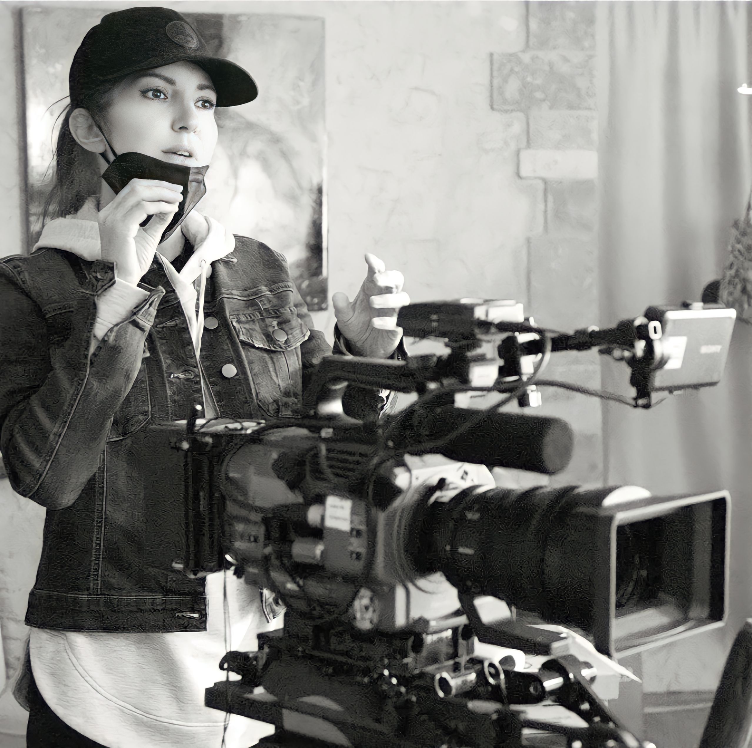 Amanda Cryer standing behind film camera.